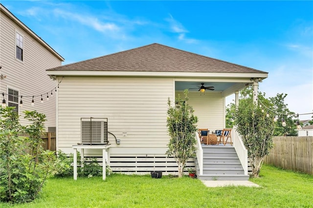 5756 Warrington Dr, New Orleans, LA 70122 - back of house featuring ceiling fan, roof with shingles, and stairs