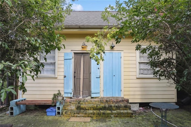 720 Port St, New Orleans, LA 70117 - view of exterior entry with roof with shingles