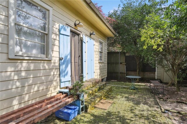720 Port St, New Orleans, LA 70117 - view of side of property with entry steps and a patio area