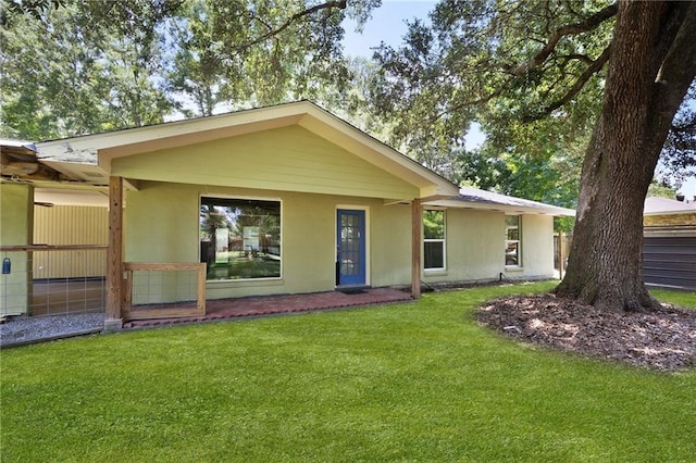 2549 Villere St, Mandeville, LA 70448 - back of house featuring stucco siding and a yard