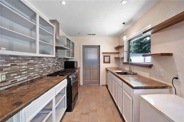 2549 Villere St, Mandeville, LA 70448 - kitchen with open shelves, stainless steel appliances, wall chimney exhaust hood, decorative backsplash, and dark countertops