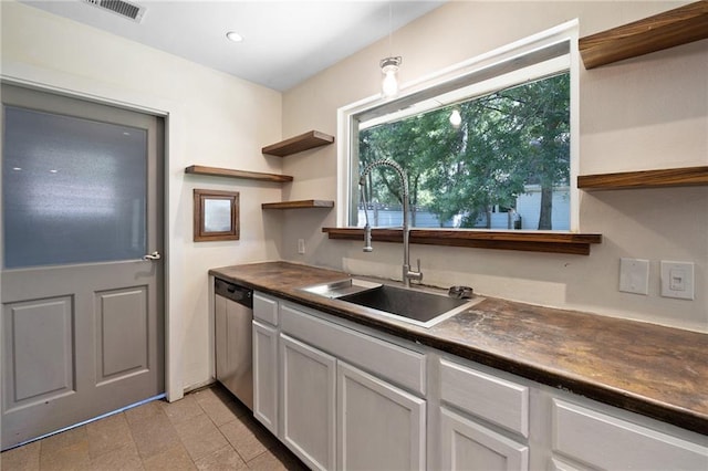 2549 Villere St, Mandeville, LA 70448 - kitchen featuring open shelves, dark countertops, dishwasher, and recessed lighting