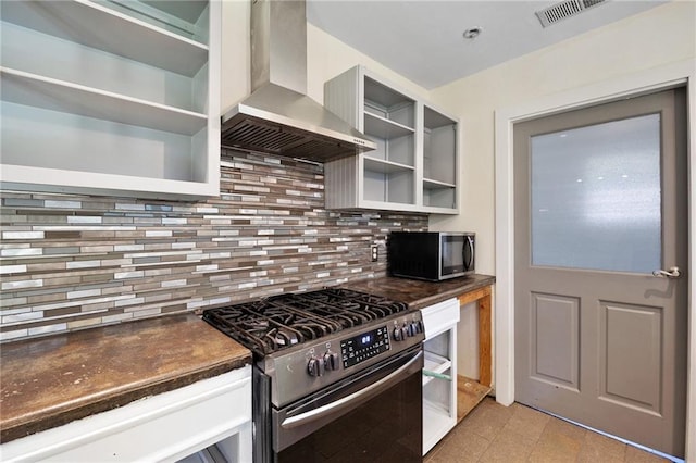 2549 Villere St, Mandeville, LA 70448 - kitchen featuring appliances with stainless steel finishes, wall chimney exhaust hood, open shelves, and dark countertops