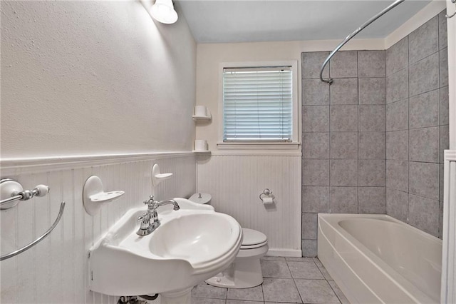 2549 Villere St, Mandeville, LA 70448 - bathroom featuring tile patterned flooring, shower / tub combination, and wainscoting