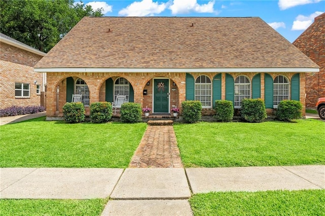 3540 Silver Maple Ct, New Orleans, LA 70131 - view of front facade with covered porch, a shingled roof, brick siding, and a front lawn