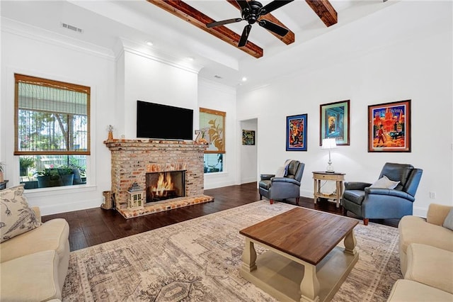225 Chateau Papillon, Mandeville, LA 70471 - living room featuring beam ceiling, ceiling fan, wood finished floors, a fireplace, and a towering ceiling