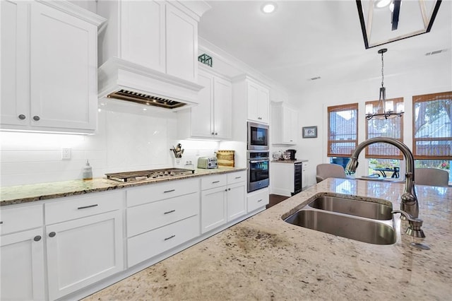 225 Chateau Papillon, Mandeville, LA 70471 - kitchen with appliances with stainless steel finishes, white cabinetry, a chandelier, and recessed lighting