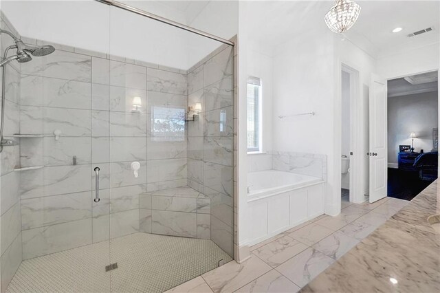 225 Chateau Papillon, Mandeville, LA 70471 - bathroom featuring a bath, a shower stall, and marble look tiles