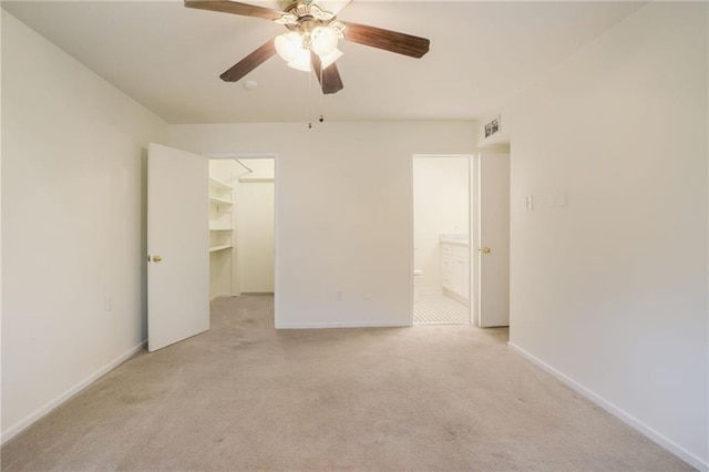 2511 St Charles Ave Unit 302, New Orleans, LA 70130 - unfurnished bedroom with a spacious closet, light colored carpet, ensuite bath, a closet, and ceiling fan