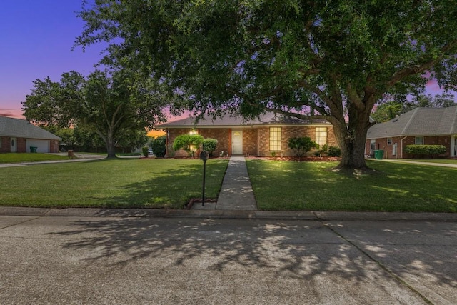 122 Warwick St, La Place, LA 70068 - view of front facade featuring a front yard and brick siding