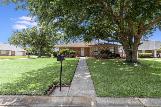 122 Warwick St, La Place, LA 70068 - ranch-style home with a front lawn and brick siding