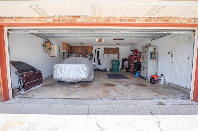 122 Warwick St, La Place, LA 70068 - garage with a garage door opener and freestanding refrigerator