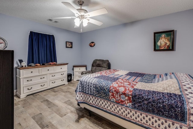 122 Warwick St, La Place, LA 70068 - bedroom with light wood-type flooring, a textured ceiling, and a ceiling fan