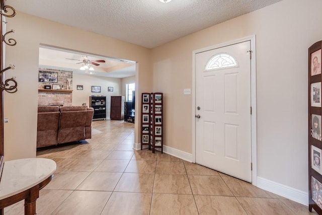 122 Warwick St, La Place, LA 70068 - entryway featuring light tile patterned floors, a ceiling fan, and a textured ceiling
