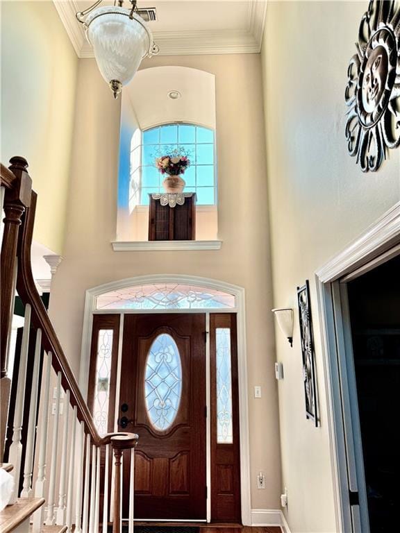 89 Catalpa Trce, Covington, LA 70433 - foyer entrance featuring a high ceiling, plenty of natural light, stairway, and crown molding