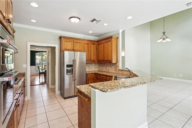 89 Catalpa Trce, Covington, LA 70433 - kitchen with high end refrigerator, a peninsula, light tile patterned flooring, brown cabinets, and ornamental molding