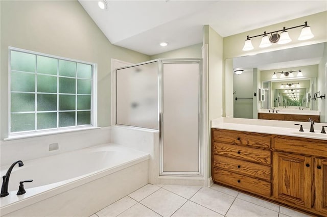 89 Catalpa Trce, Covington, LA 70433 - bathroom with vanity, a shower stall, a garden tub, vaulted ceiling, and tile patterned floors