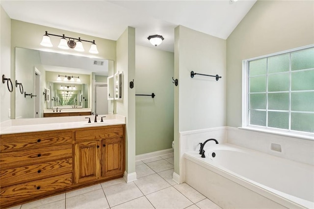 89 Catalpa Trce, Covington, LA 70433 - full bathroom featuring a garden tub, vanity, and tile patterned flooring