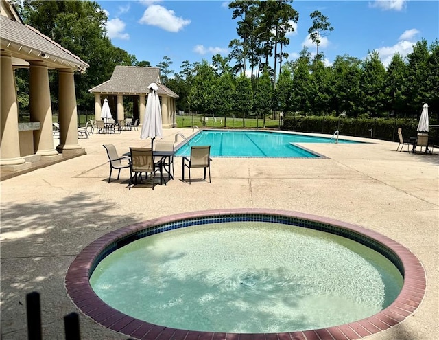 89 Catalpa Trce, Covington, LA 70433 - community pool with a gazebo, a patio area, and view of wooded area
