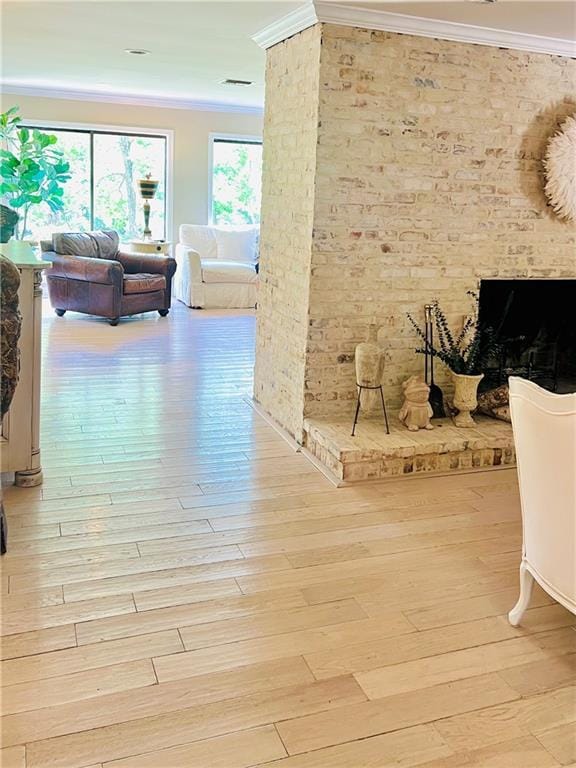 14 Riverbend Ln, Covington, LA 70433 - hallway with crown molding, light wood-style flooring, and brick wall