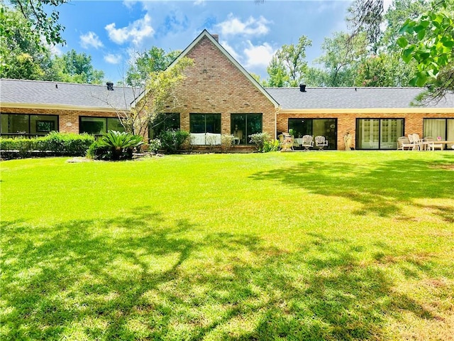 14 Riverbend Ln, Covington, LA 70433 - back of property featuring brick siding, a lawn, and french doors