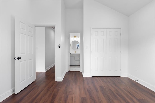 507 Westwego Ave, Westwego, LA 70094 - unfurnished bedroom featuring dark wood-type flooring, lofted ceiling, and a closet
