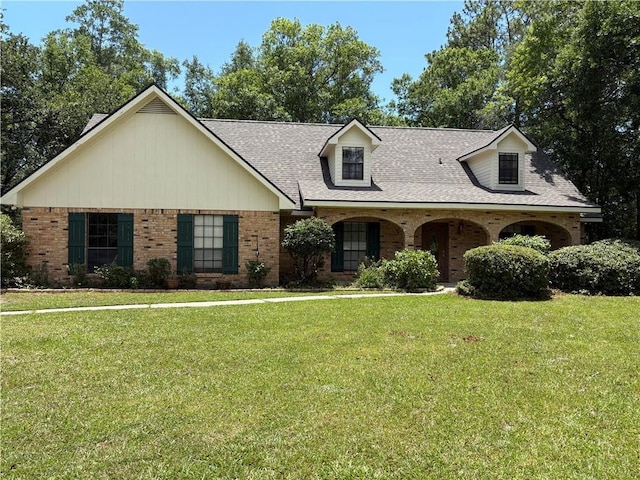 101 E Queensbury Dr, Slidell, LA 70461 - view of front of home featuring brick siding, a front lawn, and a shingled roof