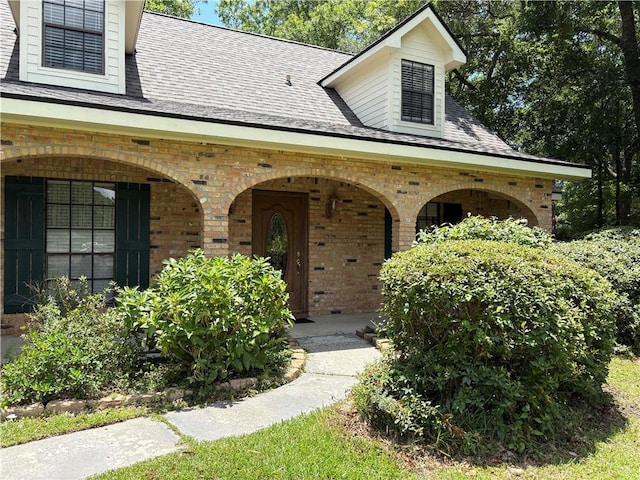 101 E Queensbury Dr, Slidell, LA 70461 - property entrance with brick siding, covered porch, and a shingled roof
