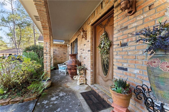 101 E Queensbury Dr, Slidell, LA 70461 - view of exterior entry with a porch and brick siding