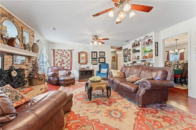 101 E Queensbury Dr, Slidell, LA 70461 - living room with ceiling fan, wood finished floors, a textured ceiling, healthy amount of natural light, and a chandelier