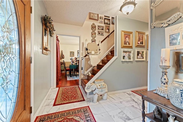 101 E Queensbury Dr, Slidell, LA 70461 - entryway with light marble finish floors, stairway, and a textured ceiling