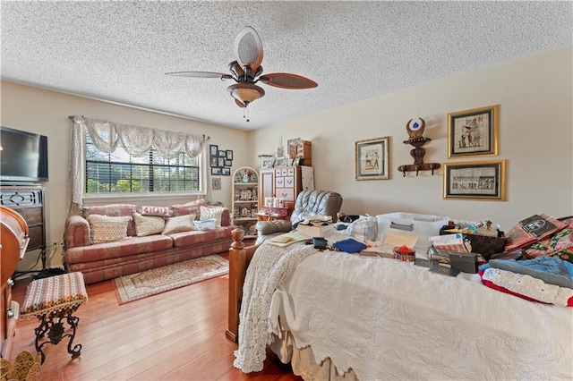 101 E Queensbury Dr, Slidell, LA 70461 - bedroom with a textured ceiling, wood finished floors, and ceiling fan
