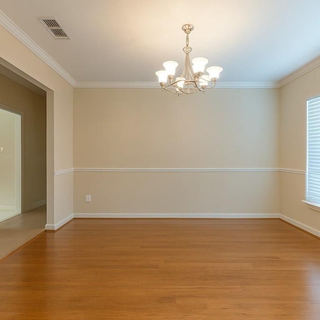 2143 Summertree Dr, Slidell, LA 70460 - empty room featuring a chandelier, light wood-type flooring, and crown molding