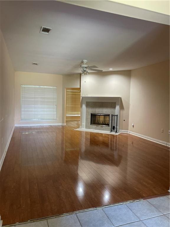 2143 Summertree Dr, Slidell, LA 70460 - unfurnished living room featuring ceiling fan, wood-type flooring, and a tiled fireplace