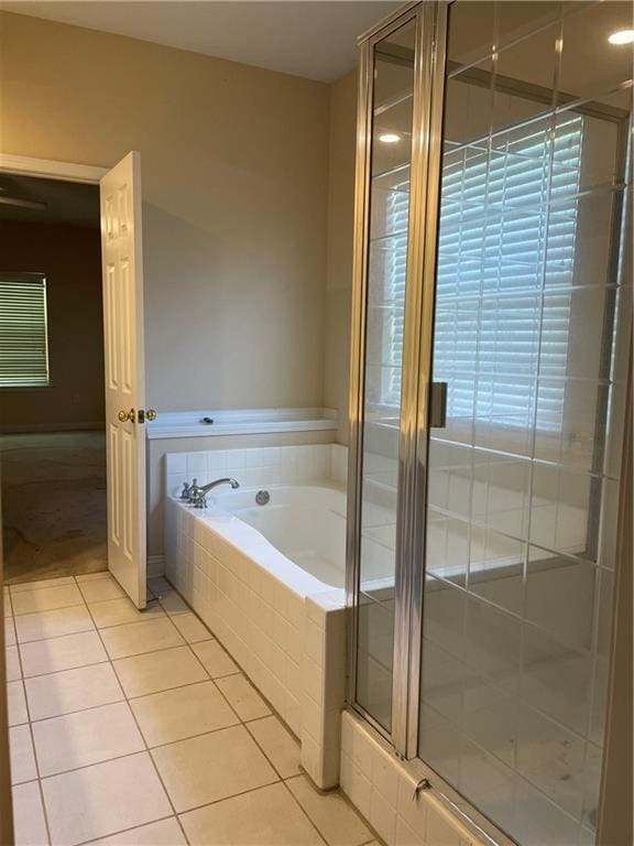 2143 Summertree Dr, Slidell, LA 70460 - bathroom with tile patterned floors, a bath, and a stall shower