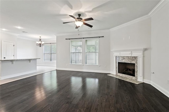 386 Knollwood Ln, Slidell, LA 70458 - unfurnished living room featuring a chandelier, a ceiling fan, a premium fireplace, crown molding, and dark wood finished floors