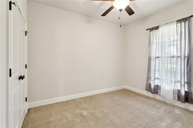 386 Knollwood Ln, Slidell, LA 70458 - spare room featuring a barn door, carpet flooring, and a ceiling fan