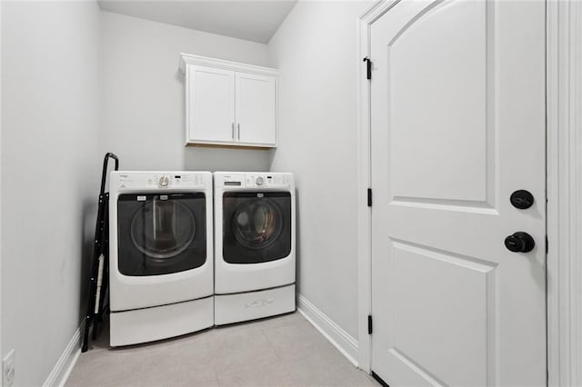 386 Knollwood Ln, Slidell, LA 70458 - laundry area featuring washing machine and clothes dryer, cabinet space, and light tile patterned floors