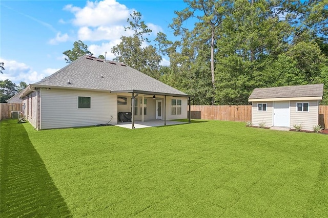386 Knollwood Ln, Slidell, LA 70458 - rear view of house featuring a patio area, a fenced backyard, a ceiling fan, and a storage unit