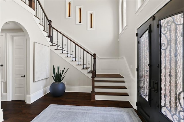 172 River Oaks Dr, La Place, LA 70068 - foyer entrance featuring wood finished floors, a towering ceiling, arched walkways, and stairway