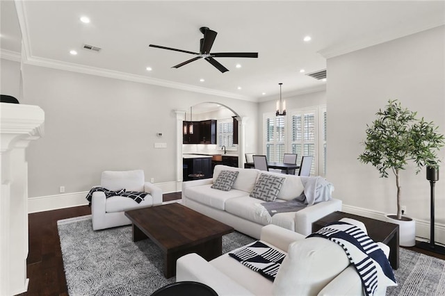 172 River Oaks Dr, La Place, LA 70068 - living area featuring decorative columns, arched walkways, wood finished floors, ceiling fan, and recessed lighting