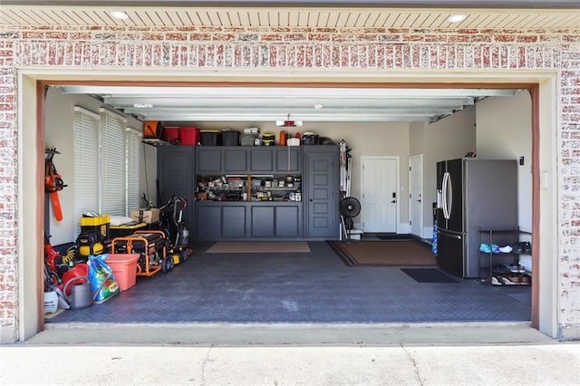 172 River Oaks Dr, La Place, LA 70068 - garage featuring driveway and stainless steel fridge with ice dispenser