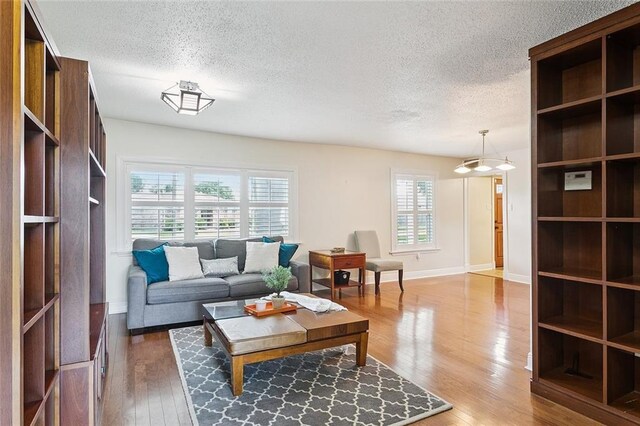 5237 Meadowdale St, Metairie, LA 70006 - living area featuring a textured ceiling and light wood-type flooring