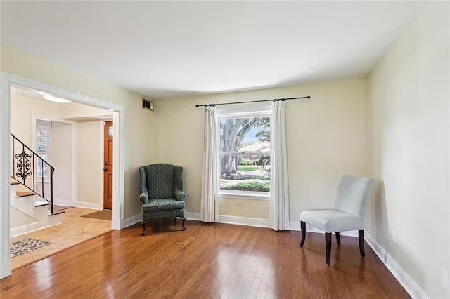 5237 Meadowdale St, Metairie, LA 70006 - sitting room featuring wood-type flooring, healthy amount of natural light, and stairs