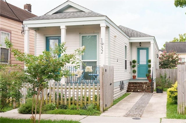 1932 Lapeyrouse St, New Orleans, LA 70116 - shotgun-style home with roof with shingles