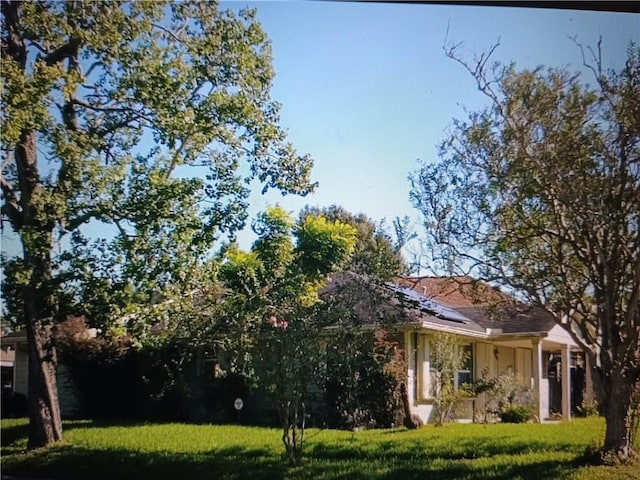 4101 Stephen Girard Ave, New Orleans, LA 70126 - view of front of home with a front yard and roof mounted solar panels