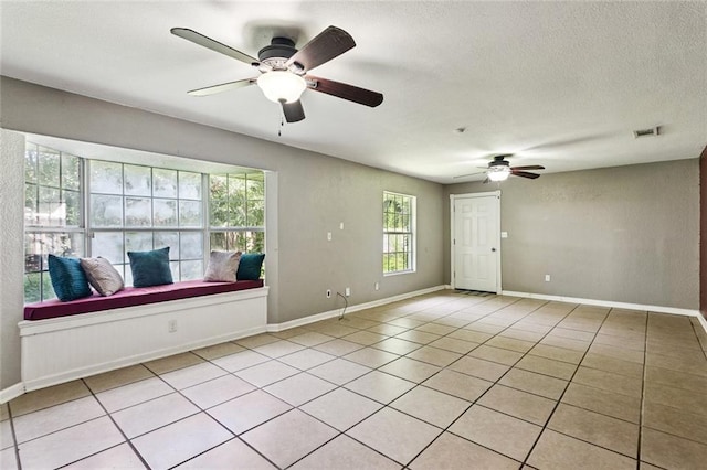 4046 Riviera Dr, Slidell, LA 70458 - spare room featuring ceiling fan, light tile patterned floors, and a textured ceiling