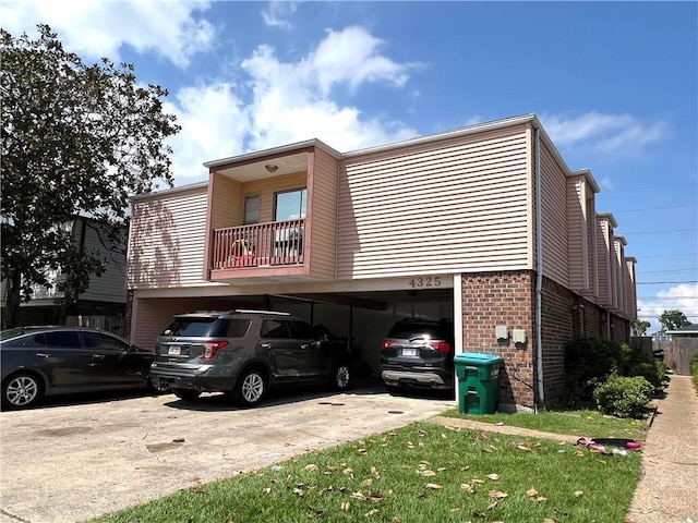 4325 Loire Dr, Kenner, LA 70065 - view of front of home with an attached garage, brick siding, and driveway