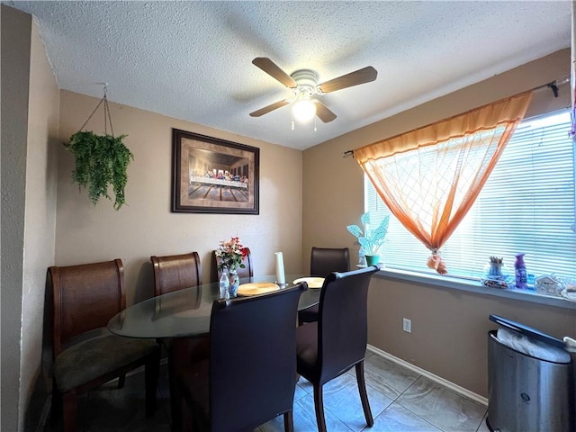 4325 Loire Dr, Kenner, LA 70065 - dining room featuring a ceiling fan, healthy amount of natural light, and a textured ceiling