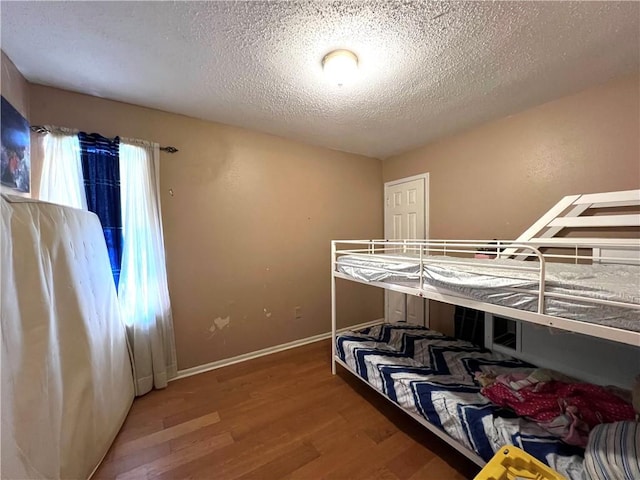 4325 Loire Dr, Kenner, LA 70065 - bedroom with wood finished floors and a textured ceiling
